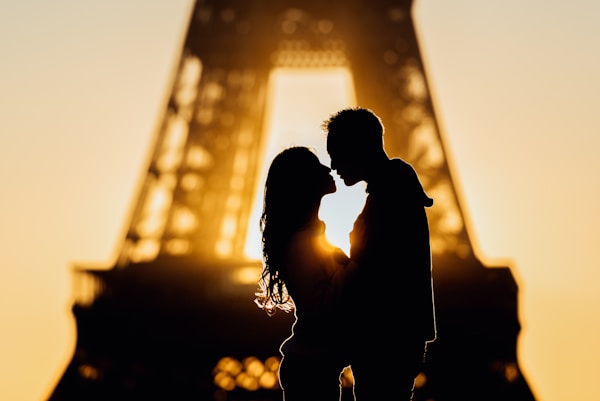 Silhouettes at sunrise in Paris, France by the Eiffel Tower